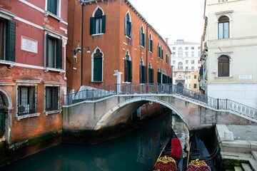 Fototapeta na wymiar Picturesque view of ancient buildings, bridge and channel with gondolas in Venice, Italy. Beautiful romantic italian city. Unique Venetian landscape.