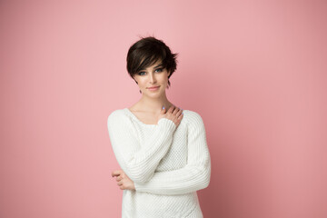 Obraz premium Beautiful young woman with shot dark hair isolated over pink background.