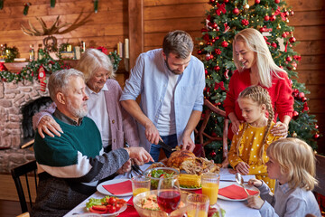 celebration, holidays and christmas concept - happy caucasian family having fun while having dinner together, on the eve of new year