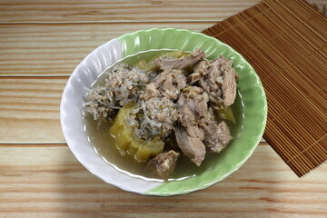 Clear soup of pork rib, minced pork and bitter gourd in the bowl. Famous traditional soft and easy digestion menu in Asia restaurant. 