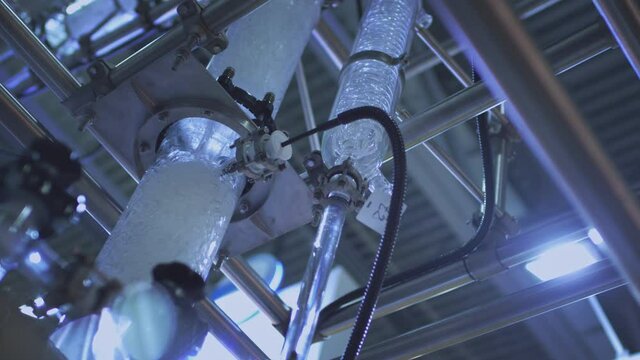 Water flows in a transparent pipe. Transparent pipe to show water flows inside the water supply system. Testing of pumps for oil flow