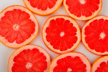 Fototapeta na wymiar Slices Red grapefruit background, Citrus fruit background