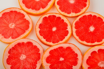 Naklejka na ściany i meble Slices Red grapefruit background, Citrus fruit background