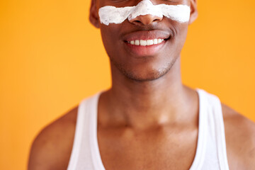 cropped african black man with problematic skin and hyperpigmentation applied mask on his face, isolated over yellow background. beauty, skincare routine. man smiles