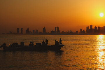 silhouette of the fishing boat and fisher man in Nurana island Bahrain