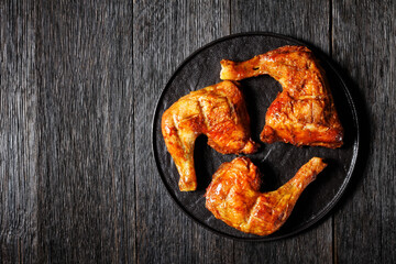 Chicken leg quarters on a wooden background