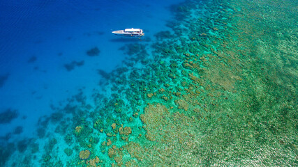 Drone flight over the beautiful Great Barrier Reef with an lonely small ship