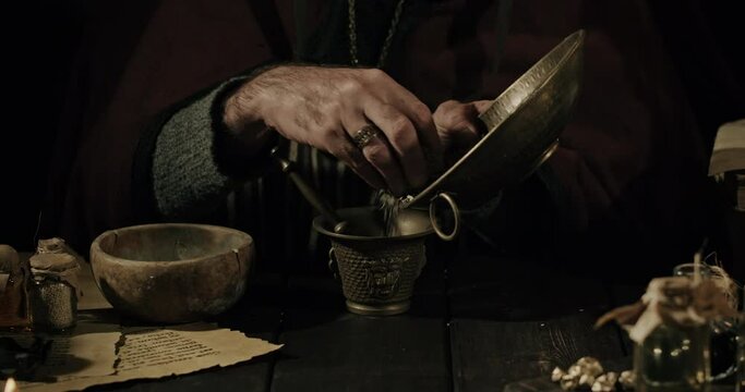 Alchemist and herbalist working in his laboratory