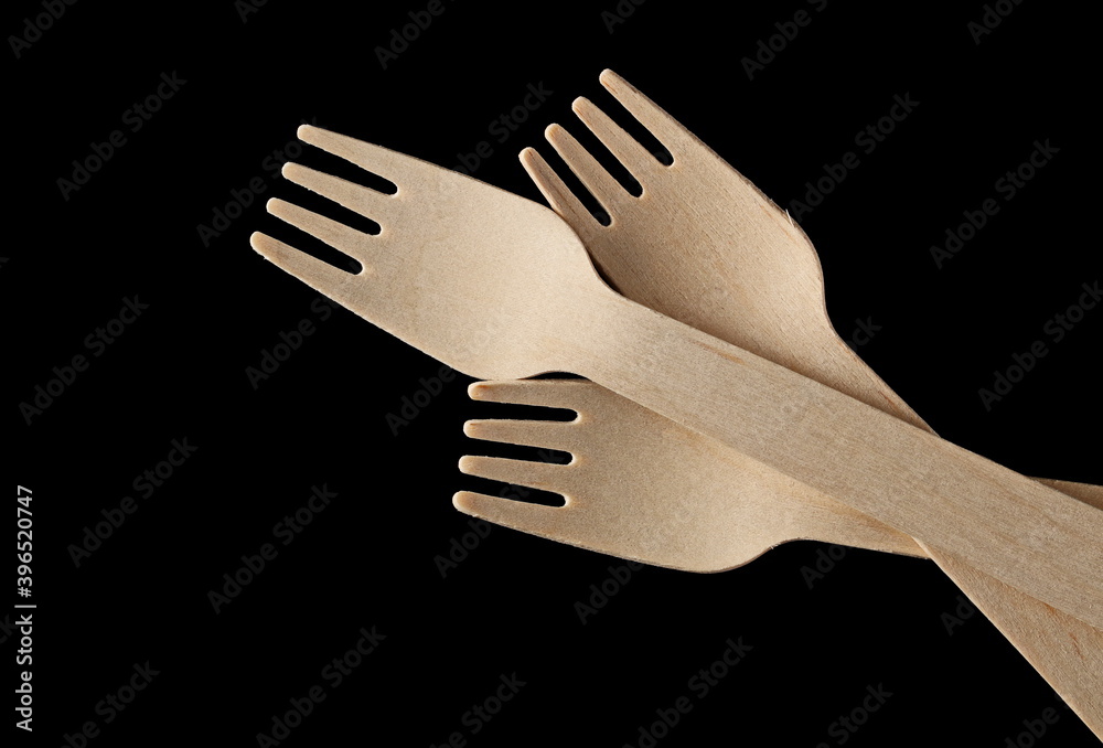 Wall mural Three wooden forks isolated on black background, top view with clipping path