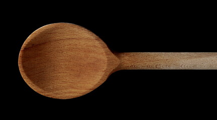 Wooden spoon isolated on black background with clipping path, top view