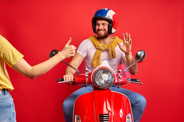 hitchhiking concept. cropped woman hitching man on motorcycle, affable friendly man say hello, glad...