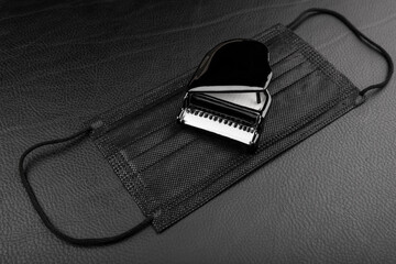 image of piano mask dark leather background