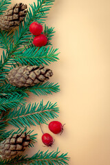 Composition with a decorated Christmas tree on a beige background with space for text. Christmas layout or greeting card. The view from the top.
