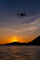 Drone flying above Iseo Lake at sunset