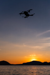 Drone flying above Iseo Lake at sunset