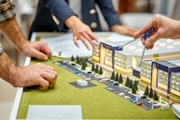 Fototapeta premium team of architects plan complex building model, 3d model construction, discussing brainstorming in the office