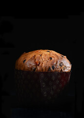artisanal panettone typical from Milano area on black background whit cutting light - obrazy, fototapety, plakaty