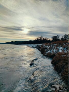 Frosty Morning By The Frozen River Bank Covered With Ice