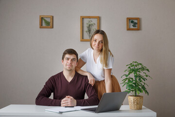Couple at home doing online shopping with laptop. man and woman looking web
