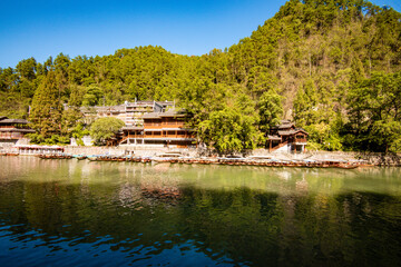 the river, the boat, stone bridge and the old houses at ancient phoenix town in the morning at...