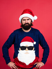 bearded man in santa claus hat and knitted sweater celebrate new year winter holiday, mood
