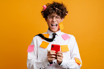 Shocked frustrated young man covered in post it