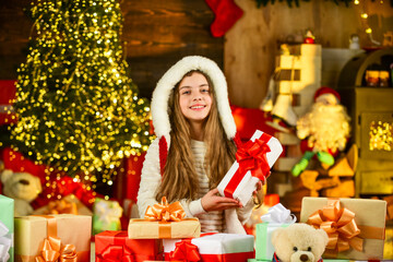 The best present. winter holiday and vacation. kid with gift. free time and joy. kid in santa costume at christmas present. morning before Xmas. Cute little girl with gifts. Kid enjoy the holiday