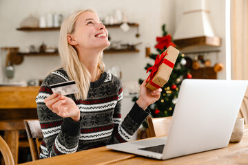 Happy smiling woman holding credit card