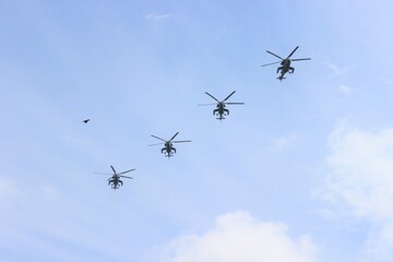 Naklejka na ściany i meble Group of helicopters and bird on the sky background