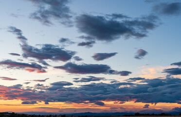 Sky background at sunset with blue clouds and mountain range