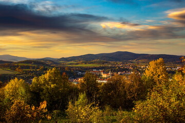 Sunset over the old Town of Cesky Krumlov, Czechia. Autumn evening in czech countryside.