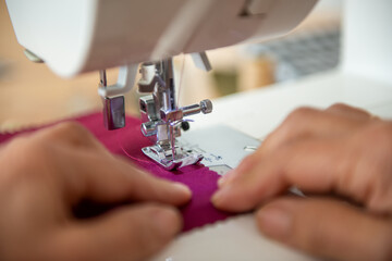 Close-up image of tailor sewing on sewing machine