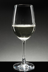 White wine in a wine glass on dark background