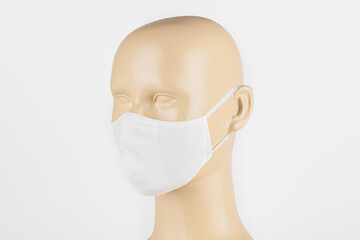 White fabric face mask on a mannequin