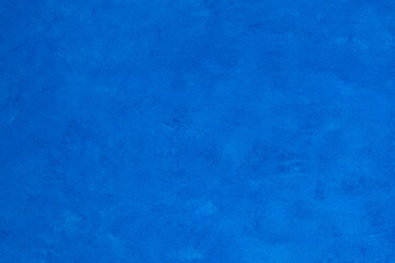 Beautiful decorative bright blue background with a nice rough texture for design and decoration. Contrast shade is ideal for presenting a product or service. Artistic stylized surface