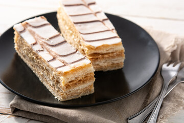 Millefoglie or French mille-feuille on white wooden table