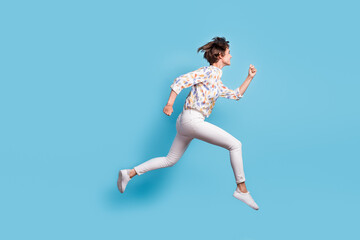 Fototapeta na wymiar Full body profile side photo of young active girl happy hurry run jump sale look empty space isolated over blue color background