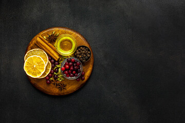 Various spices for preparing mulled wine hot drink. Cinnamon, honey, spices and cranberries