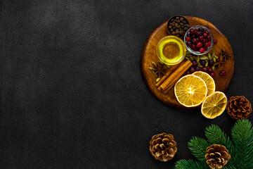 Various spices for preparing mulled wine hot drink. Cinnamon, honey, spices and cranberries
