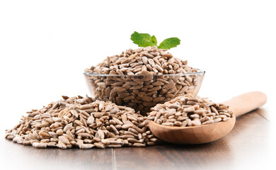 Bowl of shelled sunflower seeds isolated on white
