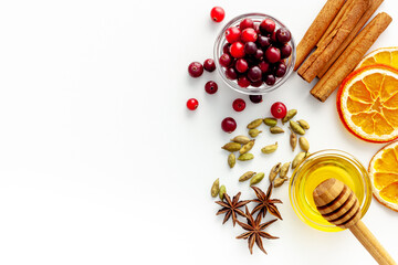 Various spices for preparing mulled wine hot drink. Cinnamon, honey, spices and cranberries