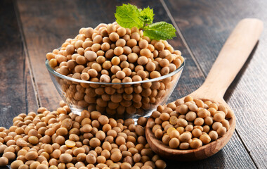 Composition with bowl of soya beans on wooden table