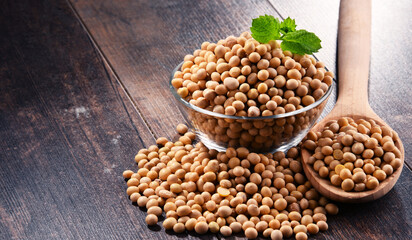 Composition with bowl of soya beans on wooden table