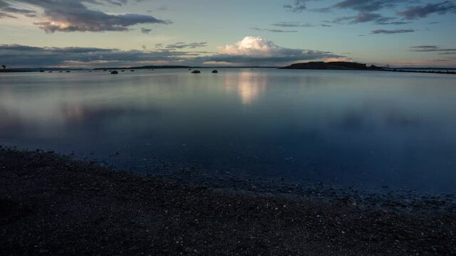 Time lapse video of clouds moving and formatting over  Oslofjord in Southern Norway. Still water reflects the clouds