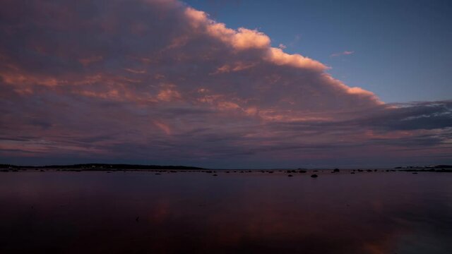 Time lapse footage of coming clouds getting dark just after sunset. Beautiful colors