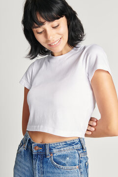 Woman in a white crop top and high waisted jeans