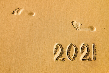 Inscription 2021 on the sand