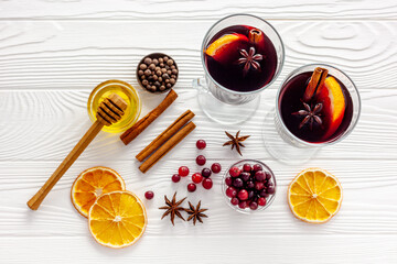 Two cups of mulled wine, spices and dry citrus fruits warming christmas drink