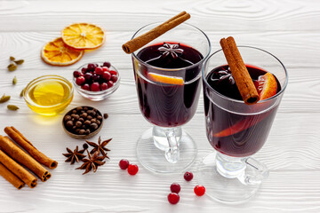 Two cups of mulled wine, spices and dry citrus fruits warming christmas drink