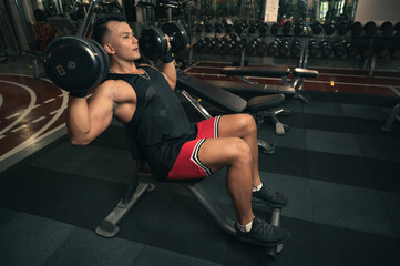 Fototapeta na wymiar fitness man with dumbbells training in gym
